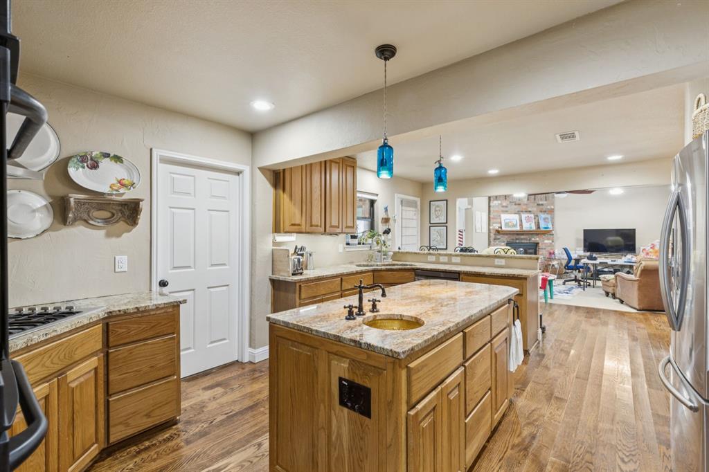 725 Stinson Road Lucas, TX 75002 - Photo 24 of 28 a kitchen with a sink appliances and wooden floor