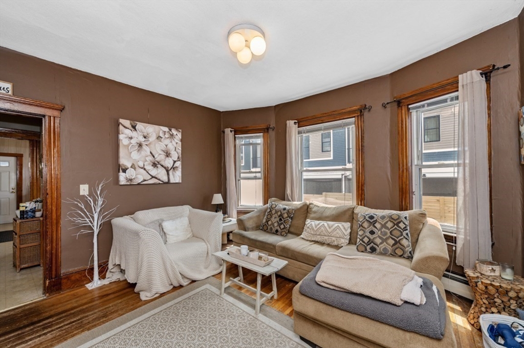 58-60 Cabot Street Everett, MA 02149 - Photo 21 of 39 a living room with furniture and a large window