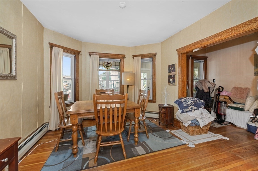 58-60 Cabot Street Everett, MA 02149 - Photo 23 of 39 a dining room with wooden floor and large windows