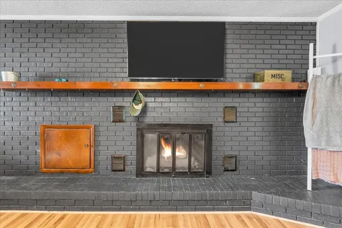 a view of a kitchen with a sink and a fireplace