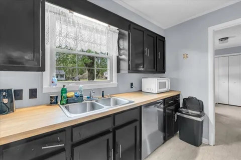 a kitchen with a sink stove and cabinets