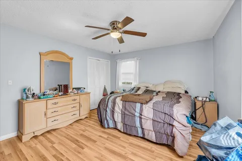a bedroom with a bed and a chandelier