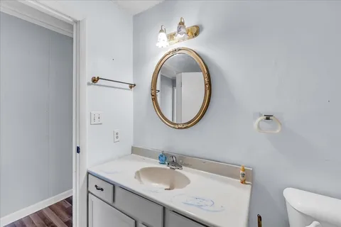 a bathroom with a granite countertop double vanity sink and a mirror