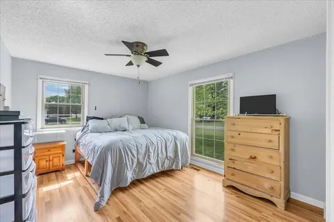 a bedroom with a bed and a window