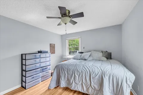 a bedroom with a bed and window