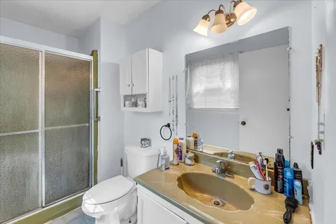 a bathroom with a sink toilet and shower