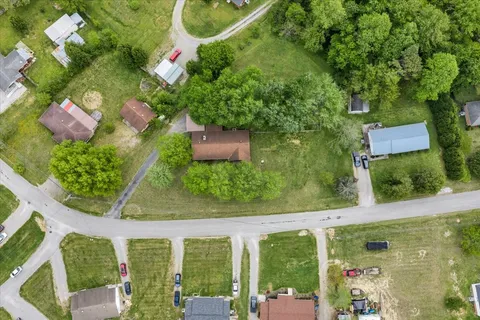 an aerial view of a residential houses with outdoor space