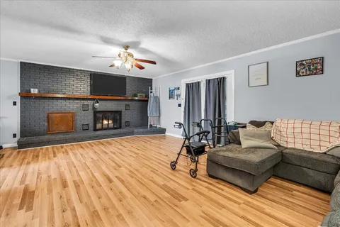 a living room with furniture a fireplace and a flat screen tv