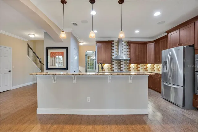 a view of a kitchen with stainless steel appliances granite countertop cabinets and a wooden floor