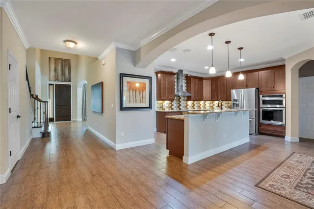a kitchen with stainless steel appliances granite countertop a sink stove and cabinets