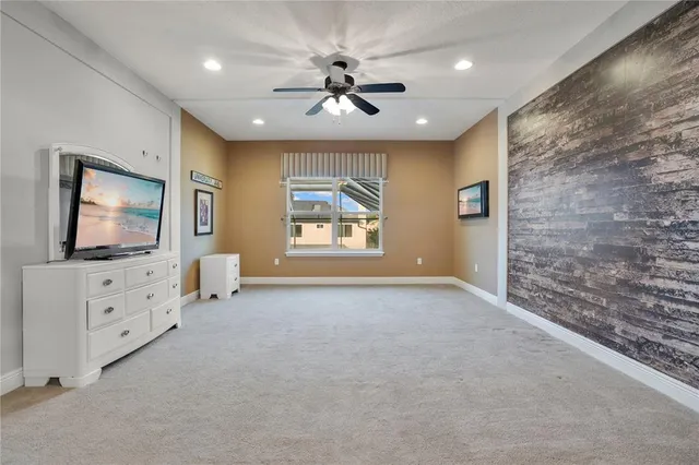 an empty room with floor to ceiling window and carpet