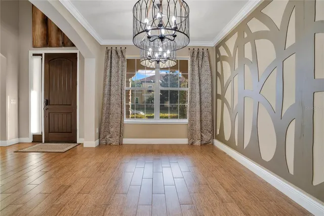 a view of a big room with wooden floor windows and entryway