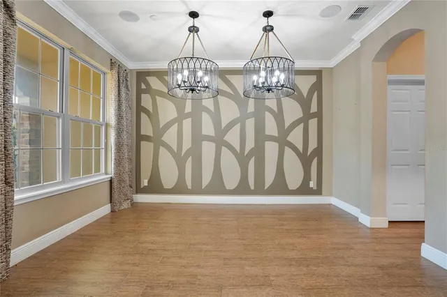 a view of hall way with furniture and chandelier