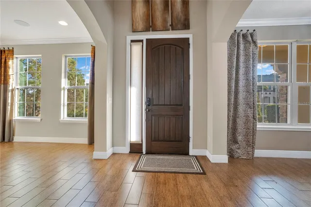 an aerial view of a house with a garden and lake view