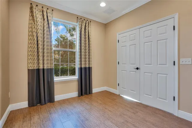 a view of a room with wooden floor and windows
