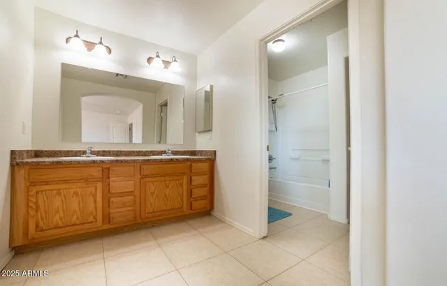 a bathroom with a granite countertop sink a toilet and a mirror