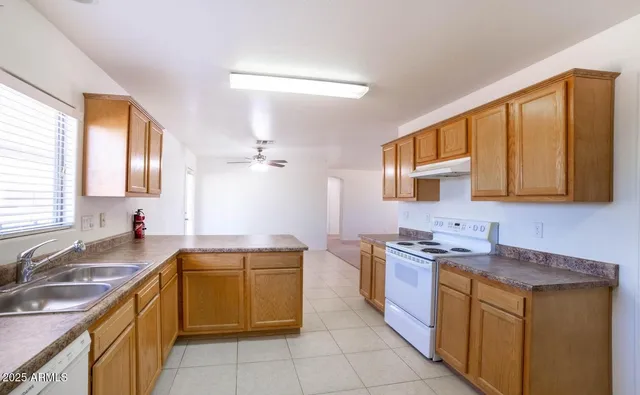 a kitchen with a sink stove and refrigerator