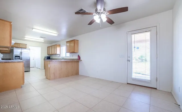 an empty room with a ceiling fan and a ceiling fan