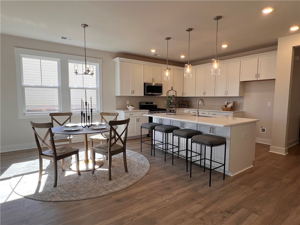 130 Tiger Lily Drive Anderson, SC 29621 - Photo 5 of 27 This bright kitchen and dining area features abundant lighting and an inviting breakfast bar.