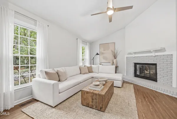 a living room with furniture and a fireplace