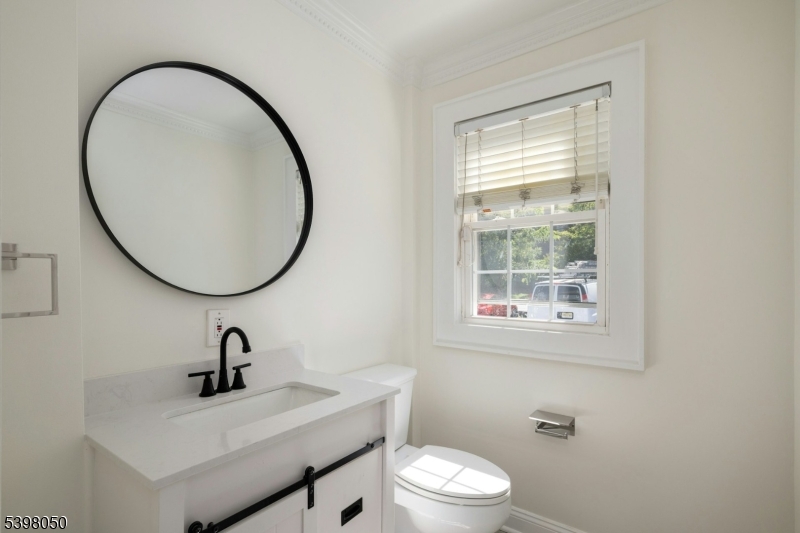 16 Walnut Street Summit, NJ 07901 - Photo 12 of 24 a bathroom with a sink a toilet and a mirror