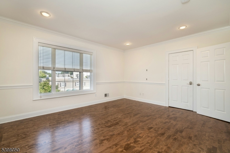 16 Walnut Street Summit, NJ 07901 - Photo 13 of 24 an empty room with wooden floor and windows
