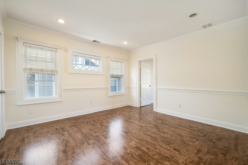 16 Walnut Street Summit, NJ 07901 - Photo 15 of 24 an empty room with wooden floor and windows