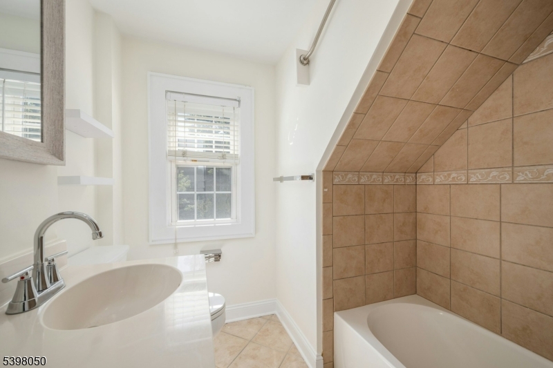 16 Walnut Street Summit, NJ 07901 - Photo 21 of 24 a bathroom with a sink a toilet and shower