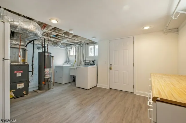 a view of a hallway with wooden floor and closet