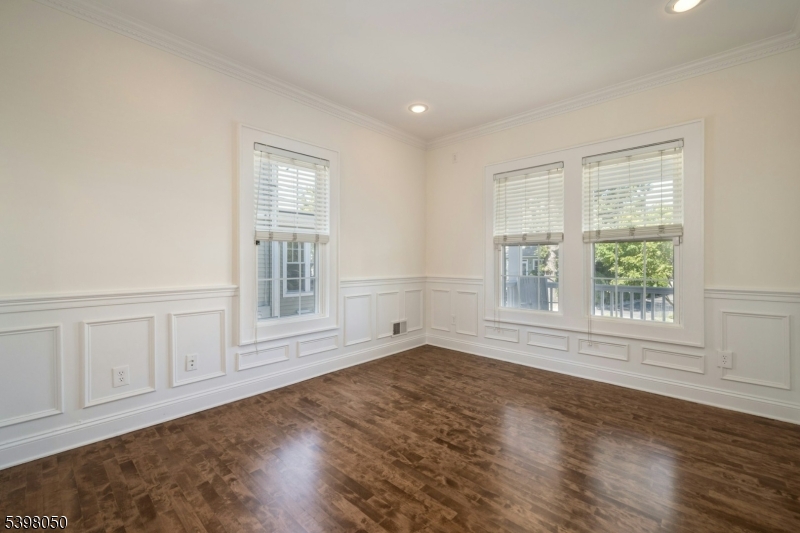 16 Walnut Street Summit, NJ 07901 - Photo 4 of 24 an empty room with wooden floor and windows