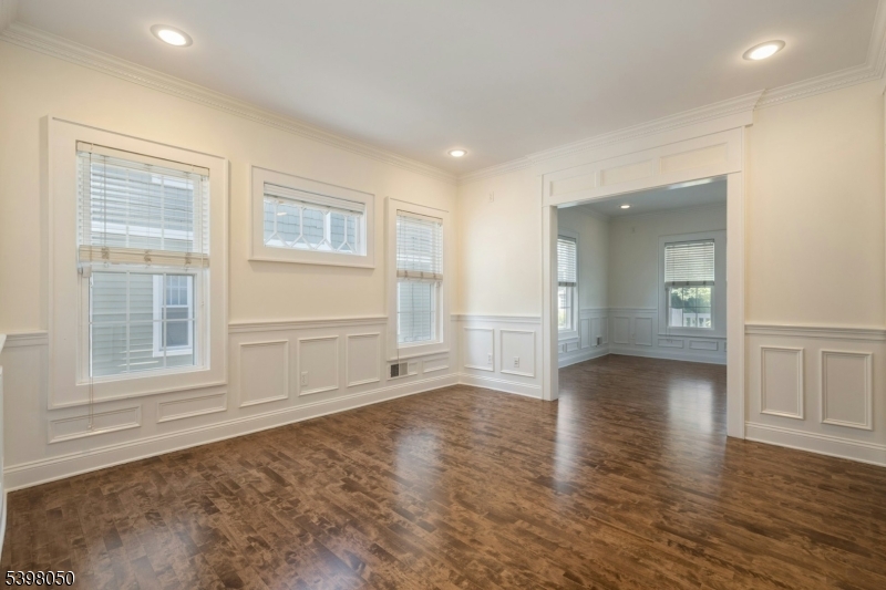 16 Walnut Street Summit, NJ 07901 - Photo 8 of 24 an empty room with wooden floor and windows