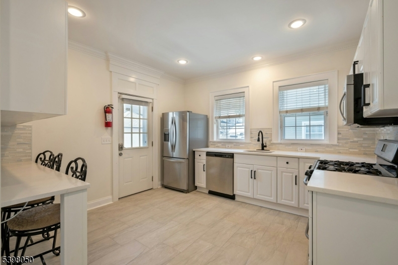 16 Walnut Street Summit, NJ 07901 - Photo 9 of 24 a kitchen that has a lot of cabinets in it and wooden floors