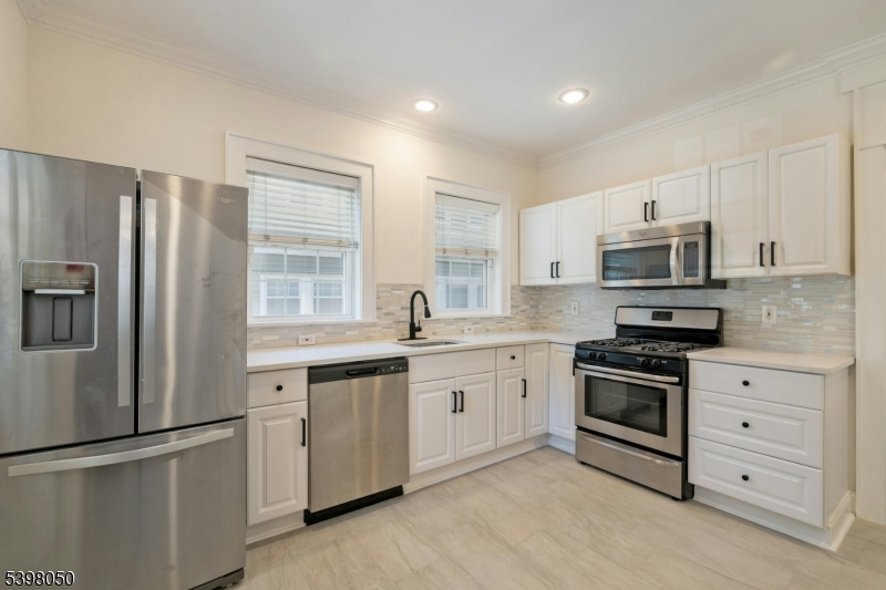 16 Walnut Street Summit, NJ 07901 - Photo 10 of 24 a kitchen with granite countertop white cabinets and stainless steel appliances