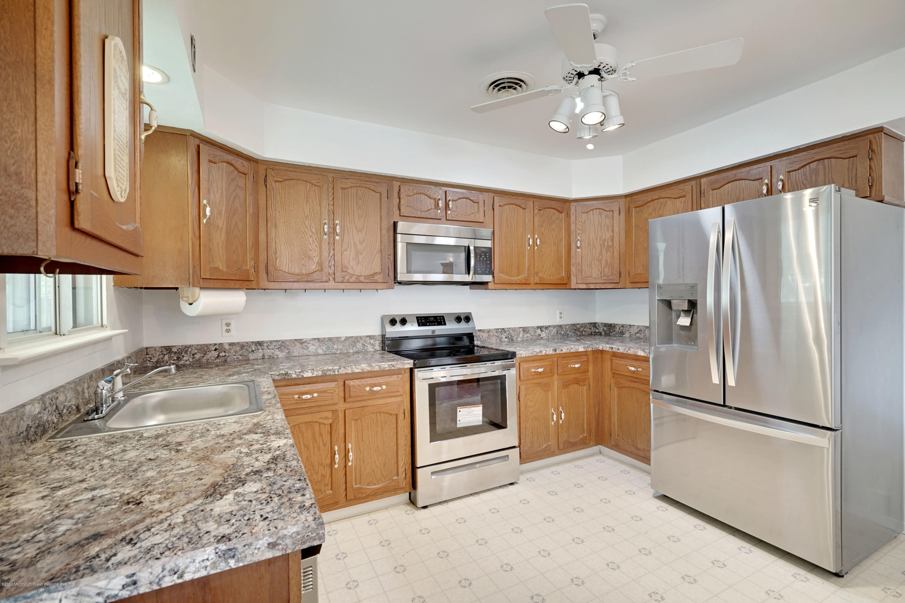 103 Sunset Road Manchester Township, NJ 08759 - Photo 22 of 57 a kitchen with granite countertop a refrigerator oven a sink and dishwasher