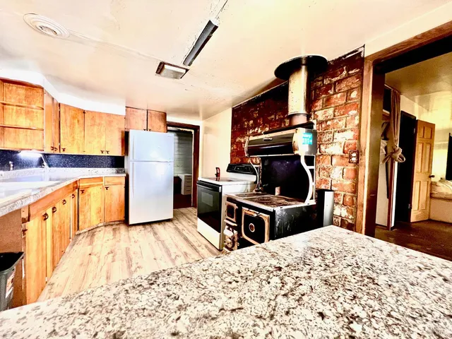 a kitchen with cabinets and steel appliances