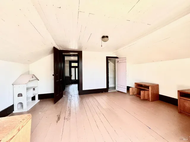 a view of a patio with a table and chairs and potted plants
