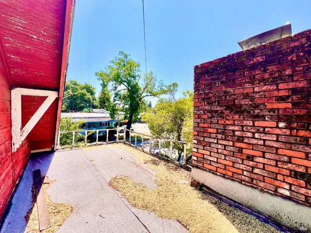 a view of roof deck with wooden fence and floor