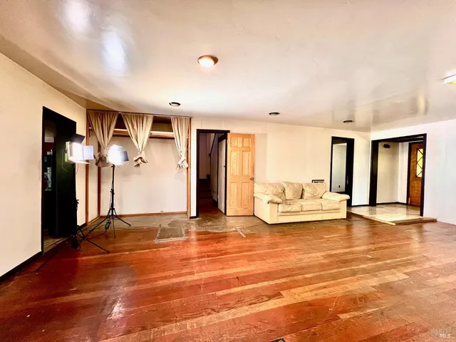 a view of a room with wooden floor and window