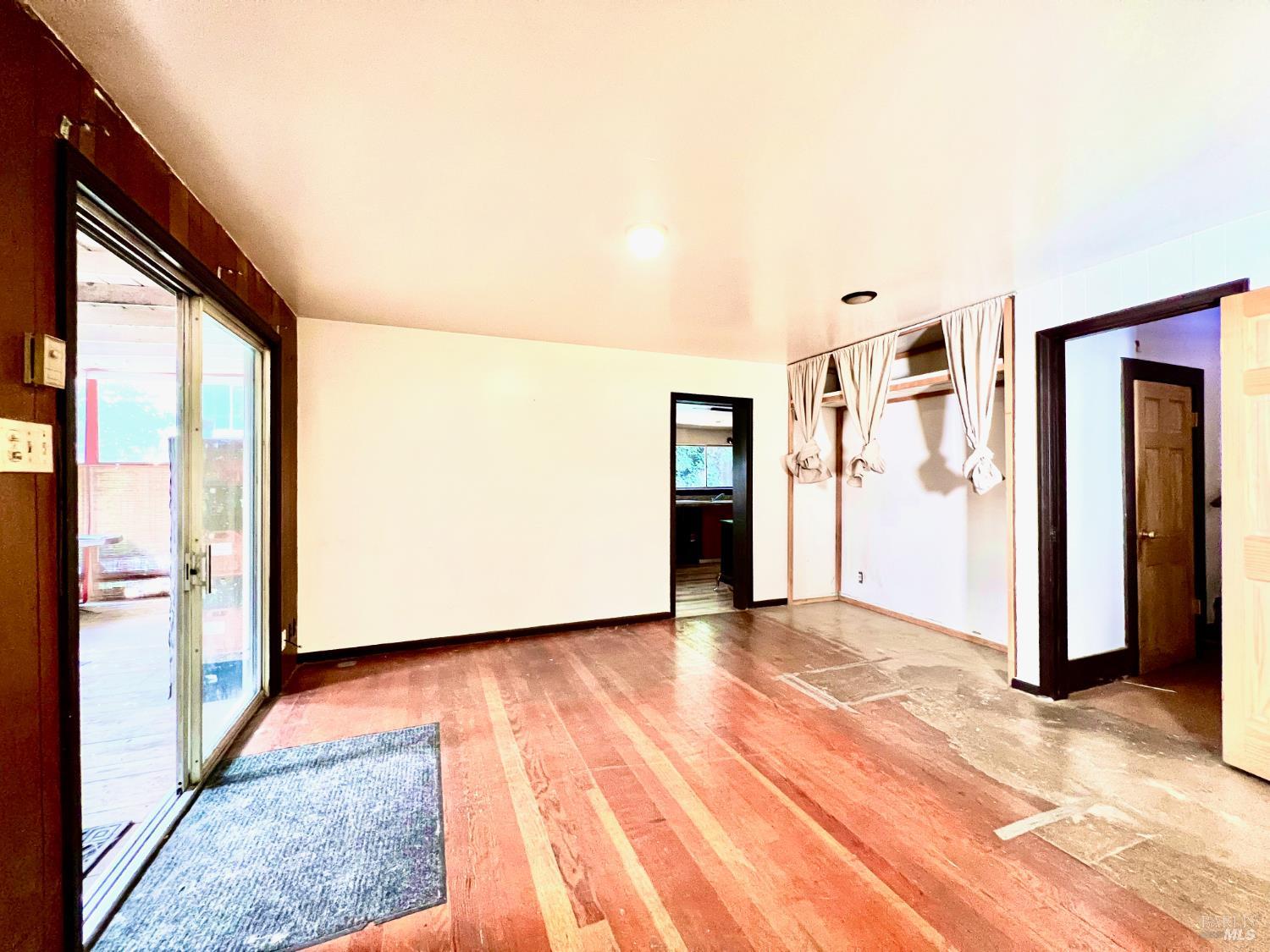 308 Coast Street Willits, CA 95490 - Photo 8 of 23 a view of an empty room with kitchen and a window