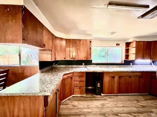 a kitchen with stainless steel appliances granite countertop a sink stove and wooden cabinets