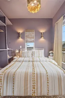 a bedroom with a bed and balcony view