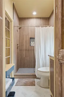 a bathroom with a shower curtain and a toilet