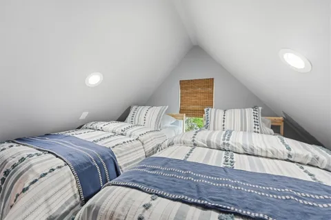 a bedroom with double bed and a couch