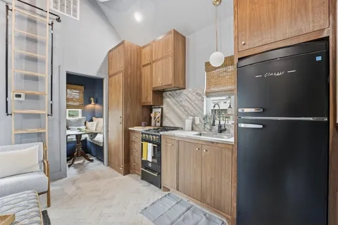 a kitchen with stainless steel appliances granite countertop a refrigerator and a stove