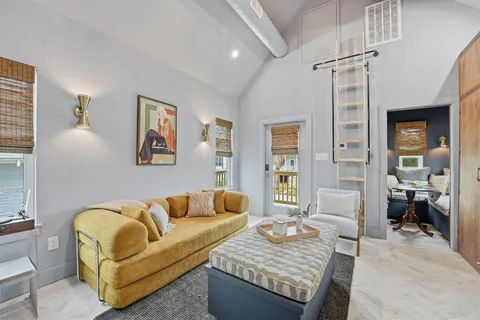 a living room with couches and painting on the wall