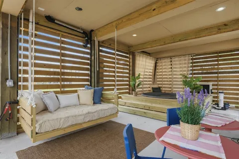 a living room with furniture and potted plants