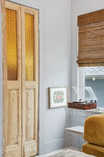 a bedroom with a bed and a window with chair