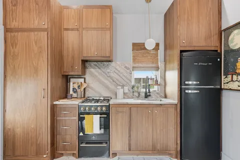 a kitchen with a refrigerator and cabinets