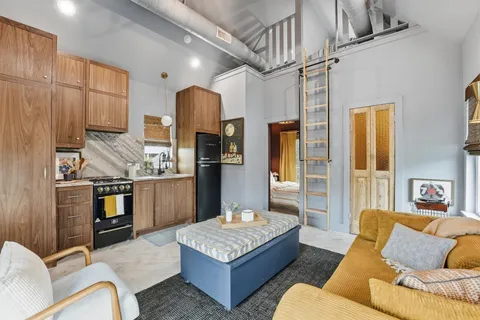 a living room with stainless steel appliances kitchen island granite countertop furniture and a kitchen view