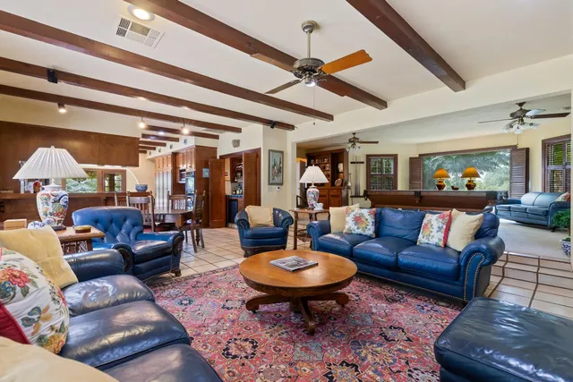 a living room with furniture a dining table and chairs